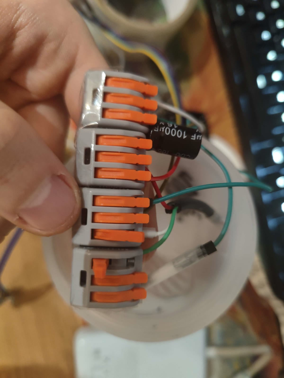 Close-up of lever connectors and a smoothing capacitor inside the orb's base