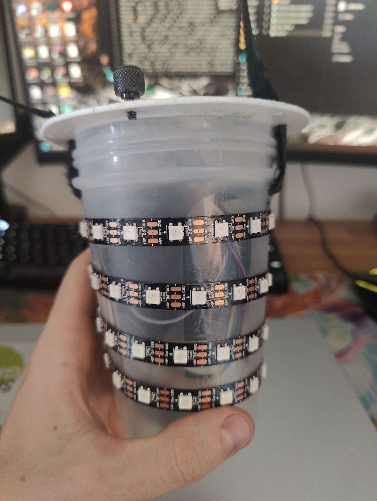 The orb's inner core wrapped in rows of addressable LED strip, with the lid fitted